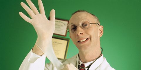 Funny doctor adjusting his rubber glove. 