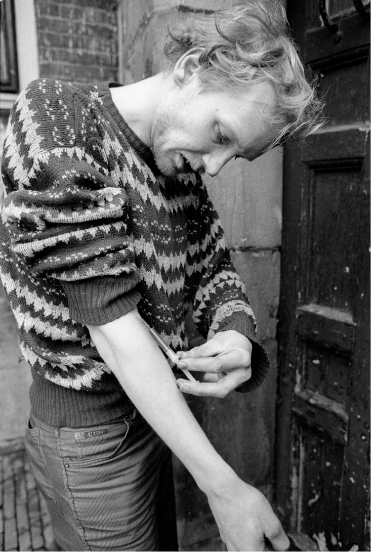 Strung out hippie shooting heroin. 