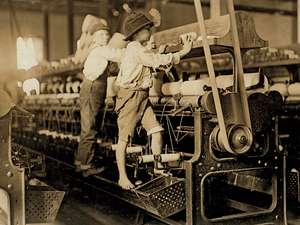 Vintage photo of young boys cleaning factory machines 