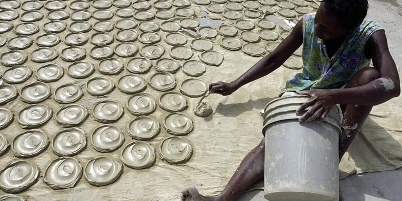 Haitian making dirt cookies. 
