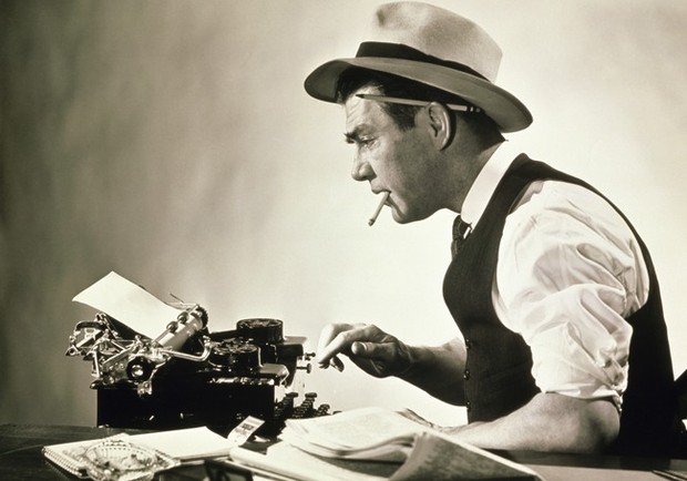 Vintage newspaperman at typewriter.