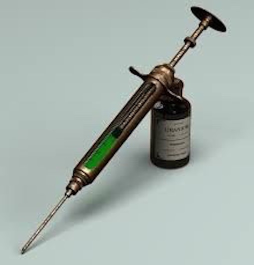 Victorian syringe with green liquid 