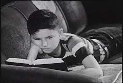 Vintage photo of young boy reading 