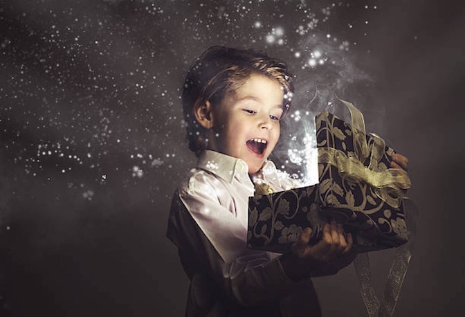Young boy opening a glowing box
