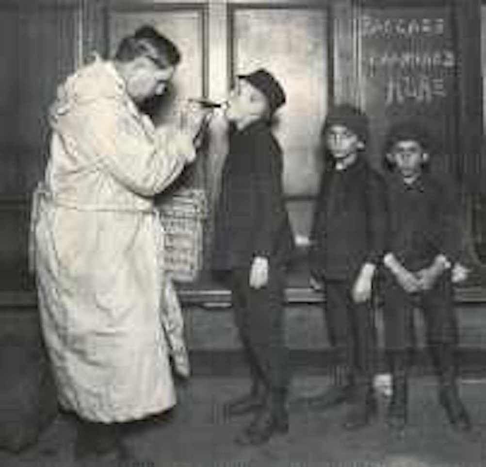 Doctor examining boys at Ellis Island 