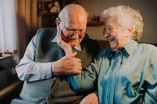 elderly couple cuddling 